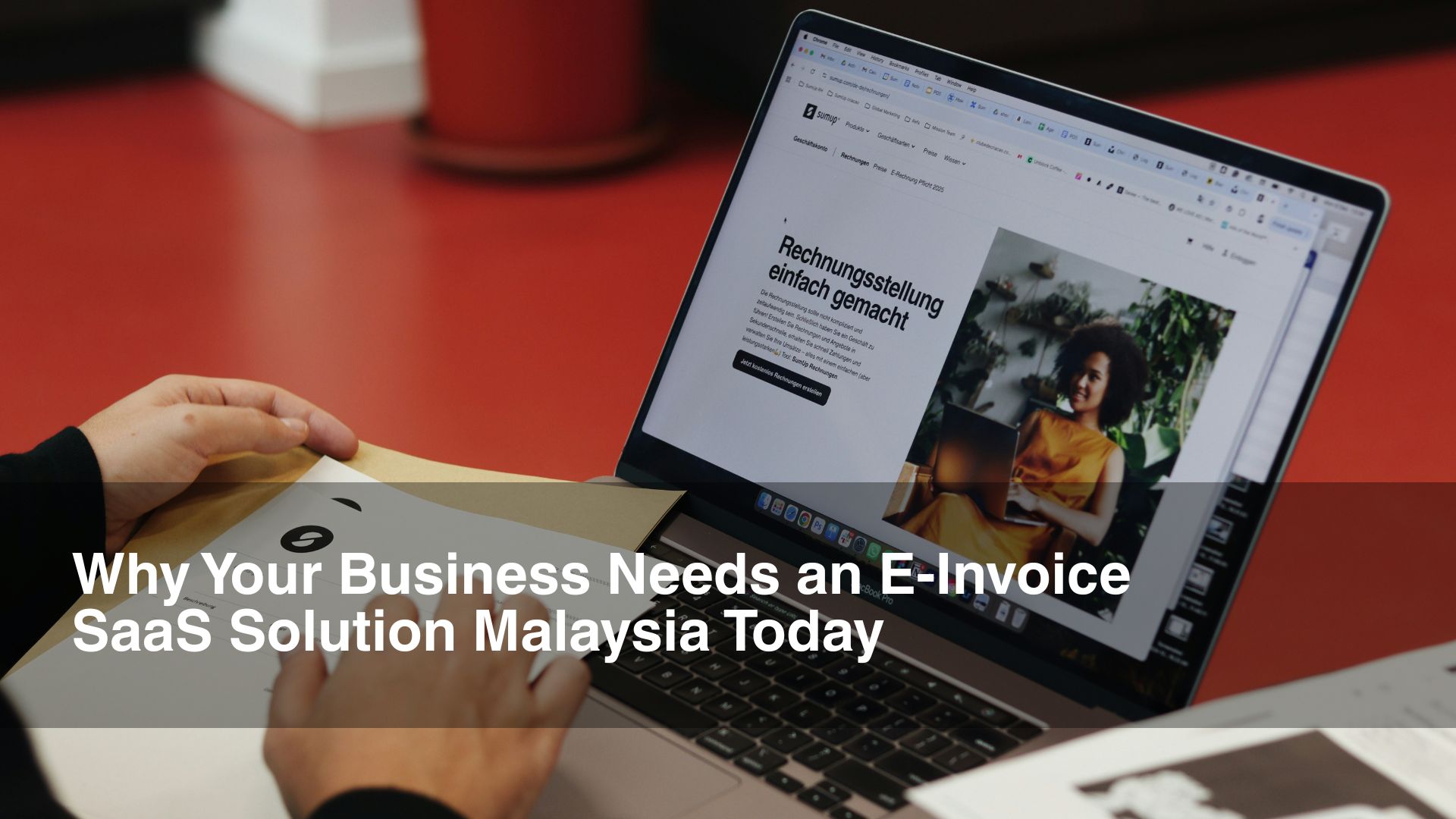 Man with einvoice in front of laptop